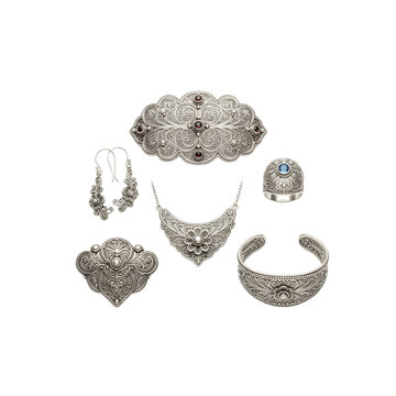 Silver filigree jewelry set including necklace earrings ring cuff and brooches on transparent background