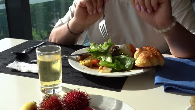 A Delicious Culinary Experience: Enjoying a Lavish Breakfast Spread with Fresh Ingredients and Refreshing Drink in a Comfortable Dining Setting