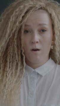Portrait of shocked young lady looking at camera feeling surprised and confused on black studio background. People and negative emotion concept.