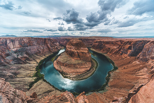 Horseshoe Bend of the Colorado River under a dramatic cloudy sky, Page, Arizona, USA
