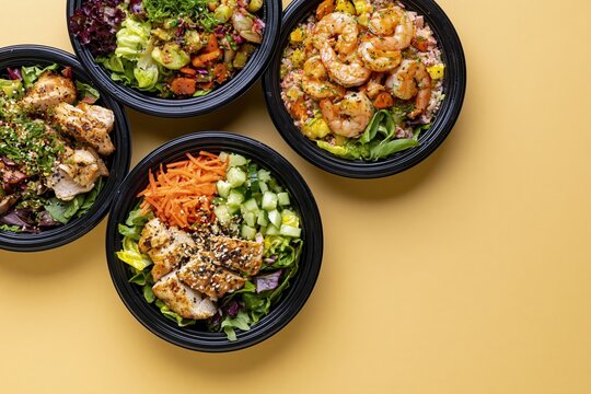The Salad Bowls Featuring Colorful Chicken, Shrimp, and Fresh Greens