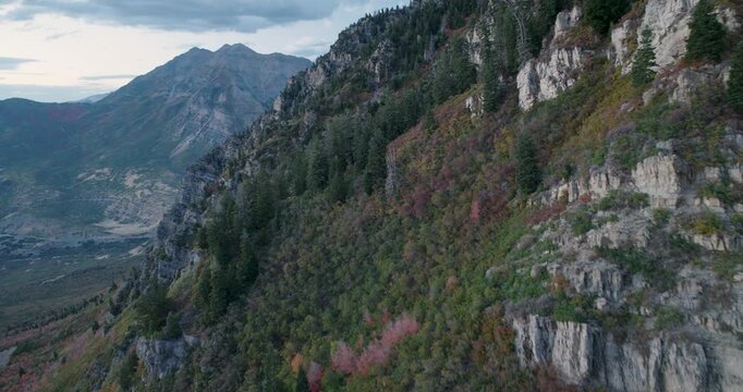Backwards Flying Aerial Shot On Rocky Mountain With Beautiful Autumn Colors