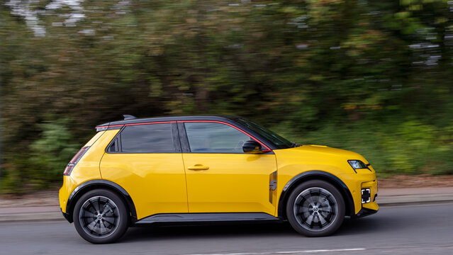 Milton Keynes; UK - Sept. 27th 2026: 2026 yellow Renault 5 iconic + e-tech electric car driving on a British road