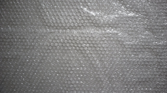 Full frame detailed bubble wrap texture. Perfect background template for designs related to packaging, logistics, shipping, and protection of fragile goods. Close up abstract pattern. Photography.
