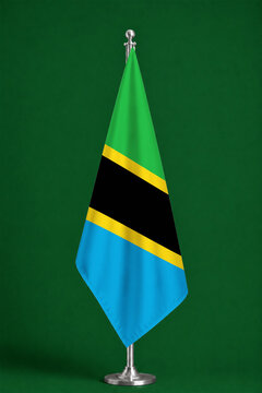 3D illustration. Flag of Tanzania on a ceremonial standing flag on a pole with a metal base.