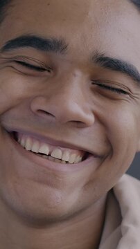 Slow motion portrait of joyful African American man laughing looking at camera on black background. Happy people and positive emotion concept.