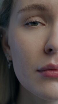 Slow motion portrait of miserable young woman looking at camera pursing lips on black studio background. People and negative emotion concept.
