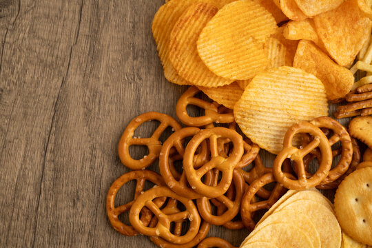 Mix of variety snack chips pretzel and cracker, junk crunchy food.