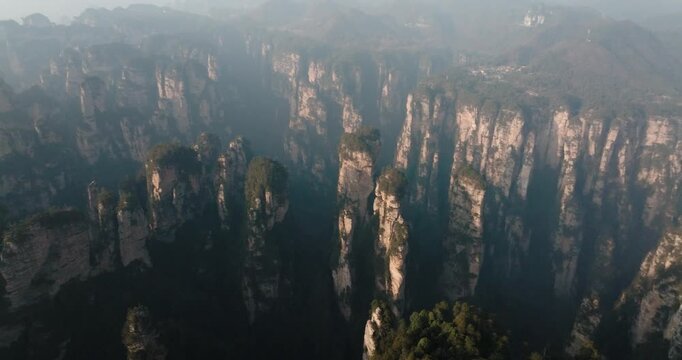 Sunlit sandstone cliffs and pillars span Zhangjiajie, China.