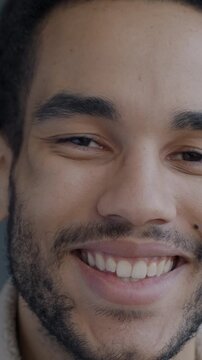 Close-up portrait of happy African American man smiling looking at camera on black color background. People and positive emotion concept.