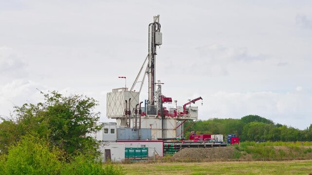 Slow horizontal pan across a deep drilling rig near R&oslash;dbyhavn, Denmark, during exploration drilling for onshore geological CO2 storage, CCS site characterization and subsurface investigation.
