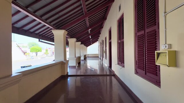 Walking Through a Historic Pillared Corridor at Fort Rotterdam, Makassar, Indonesia