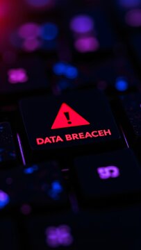 Glowing data breach warning illuminates a dark keyboard in this cyber security concept, drawing attention to the digital risks and privacy concerns that accompany modern technology