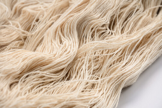 Natural fiber yarn textile beige soft thread closeup texture material fabric craft detail