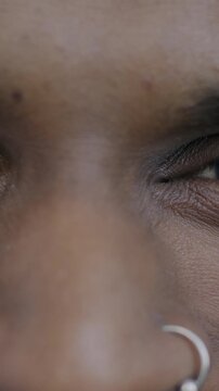 Close-up portrait of male eyes while happy Indian man looking at camera with joy. Positive emotion and human body part concept.