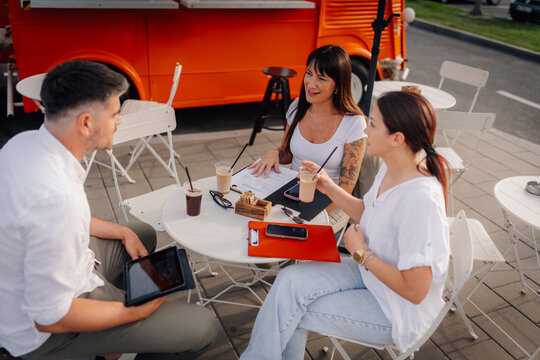 Group of friends discussing ideas at food truck