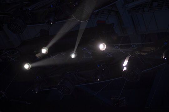 Professional stage lighting fixtures on ceiling steel truss with copy space