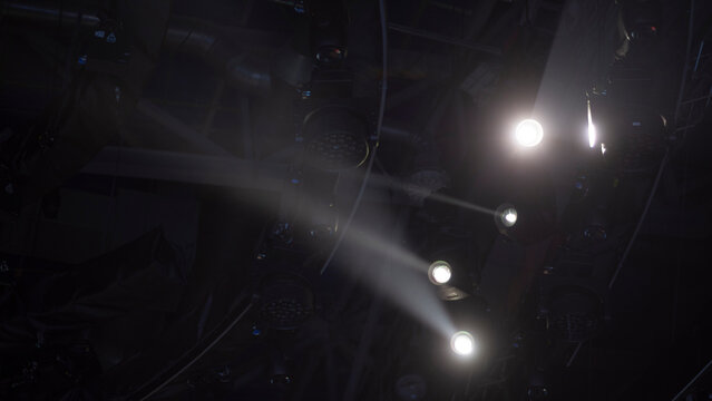 Cinematic studio light beams cutting through haze with copy space