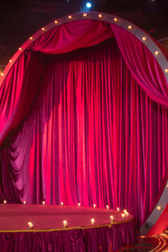Red velvet theater curtain on retro stage with lights and copy space