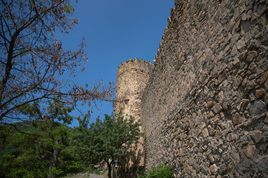 Ancient stone wall and watchtower of Ananuri fortress with copy space