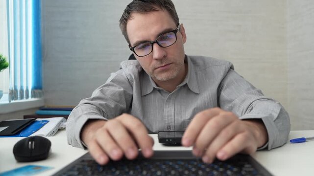 Office, programming and man with technology, code and typing with data analytics, cyber security and software update. Male person, programmer and developer with laptop, database and cloud computing