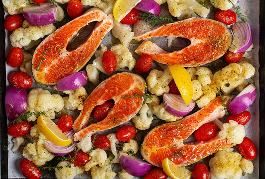 Raw Salmon with Cauliflower and Tomatoes Ready for Roasting. Top view, texture