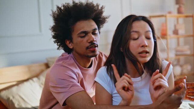 Man shouting angry girlfriend bedroom. Interracial couple quarrel conflict home.