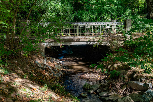 charming, ornate stone and iron bridge spanning the Rambach stream inside the historic Kurpark Wiesbaden