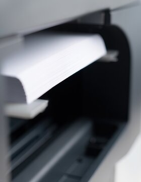 Close-up of a stack of white paper ready for printing.