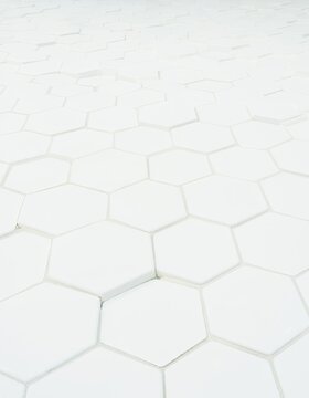 A repeating pattern of white hexagonal tiles receding into the distance.