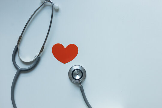 close up on red heart shape with stethoscope on white background for health checkup annual and medical process concept