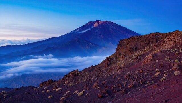Volcanic Mountain Rising Above Clouds At Sunrise