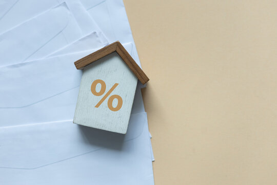 close up top view group of home model and bank invoice mail on beige color background with space for financial loan concept
