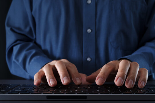 Businessman using computer at desk. Closeup of hands and keyboard. Business technologies.