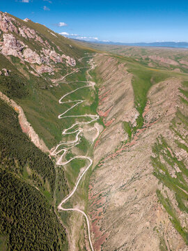 Winding Teskey Torpok road climbs steep mountain valley toward Song Kol, Kyrgyzstan