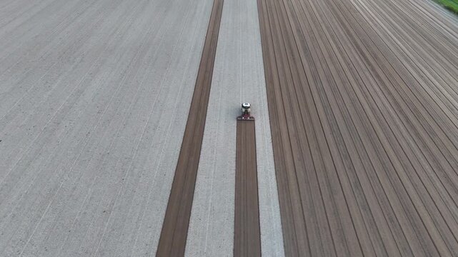 Po Valley agricultural field in Italy with a GPS guided tractor following precise parallel cultivation passes, illustrating precision farming technology and digital field management, static