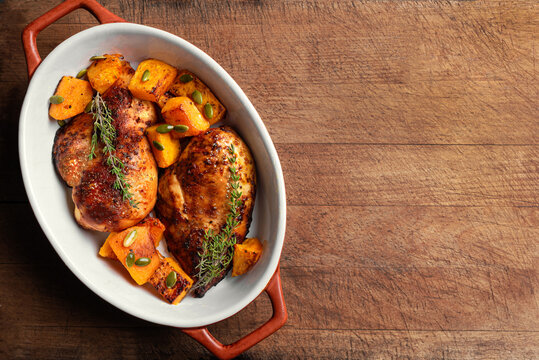 Autumn meal: roasted chicken breast and pumpkin with herbs