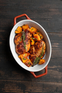 Autumn meal: roasted chicken breast and pumpkin with herbs