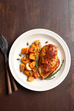 Autumn meal: roasted chicken breast and pumpkin with herbs
