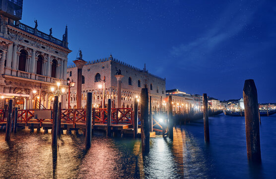 Evening Venice Italy. View with water at Doges Palace. Picturesque panorama historical old town with illuminated street lamp at bank Grand Canal.
