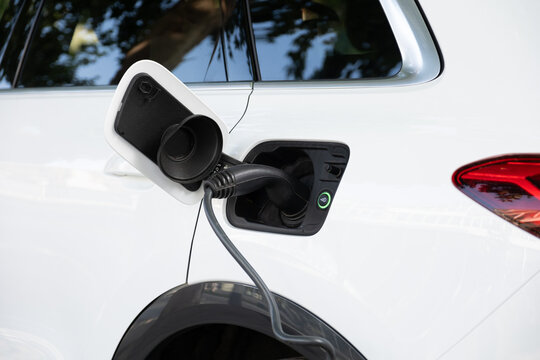 White electric car charging outdoors for sustainable energy
