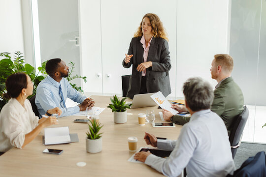 Businesswoman leads a corporate meeting with colleagues in the office