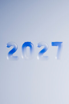 The year 2027 is displayed in blue 3D typography for New Year