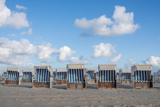 Blue and white beach baskets on the sand in St Peter Ording