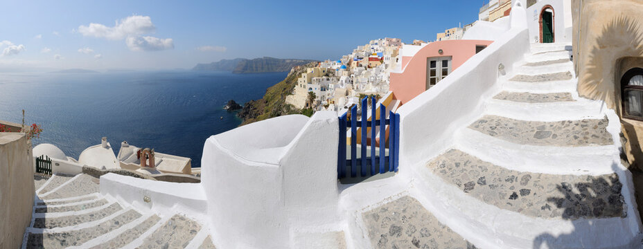 Greece, View of Oia village with cobbled path and blue gate at Santorini