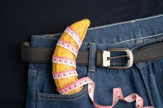 Banana with measuring tape on jean trousers, penis health.