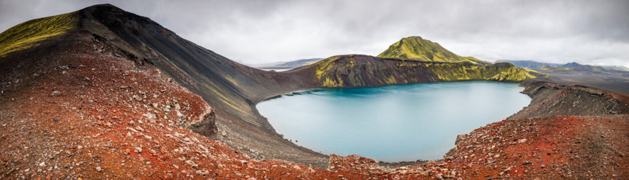 Turquoise water fills the Hnausapollur crater lake in Iceland