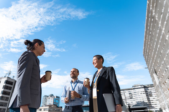 Business colleagues talking during a coffee break outdoors