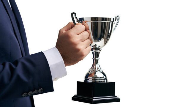 Businessman in dark suit holding a shiny silver trophy cup with black base