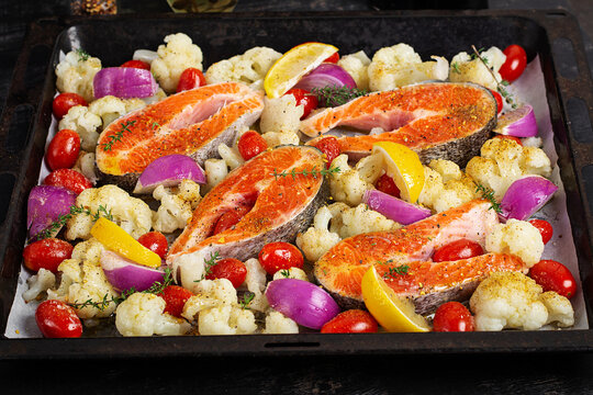 Fresh Salmon and Vegetables on Baking Tray Before Roasting. Overhead